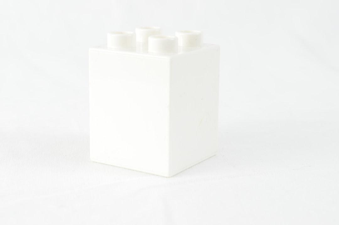 A white box with four white candles in it from Marcella Marcella on Unsplash