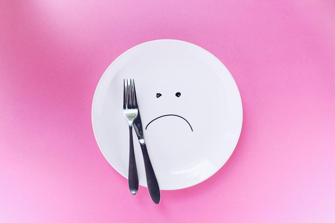Silver fork and knife on plate from Thought Catalog on Unsplash