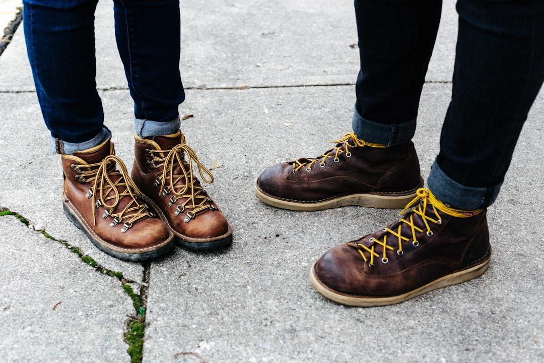 Two person wearing brown leather boots from Don Ross III on Unsplash