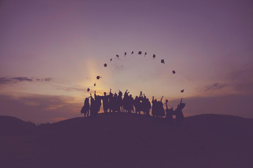 Silhouette of people standing on hill from Baim Hanif on Unsplash