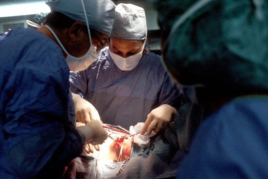 Doctor and nurse during operation from National Cancer Institute on Unsplash