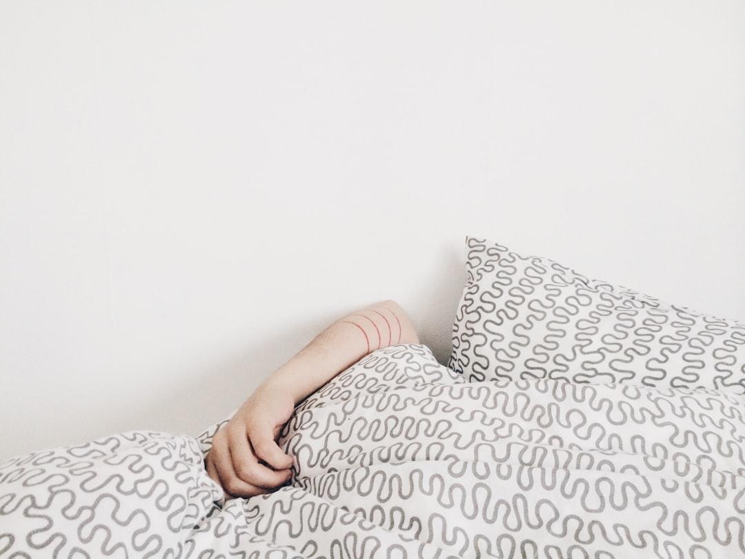 Person lying on bed from elizabeth lies on Unsplash