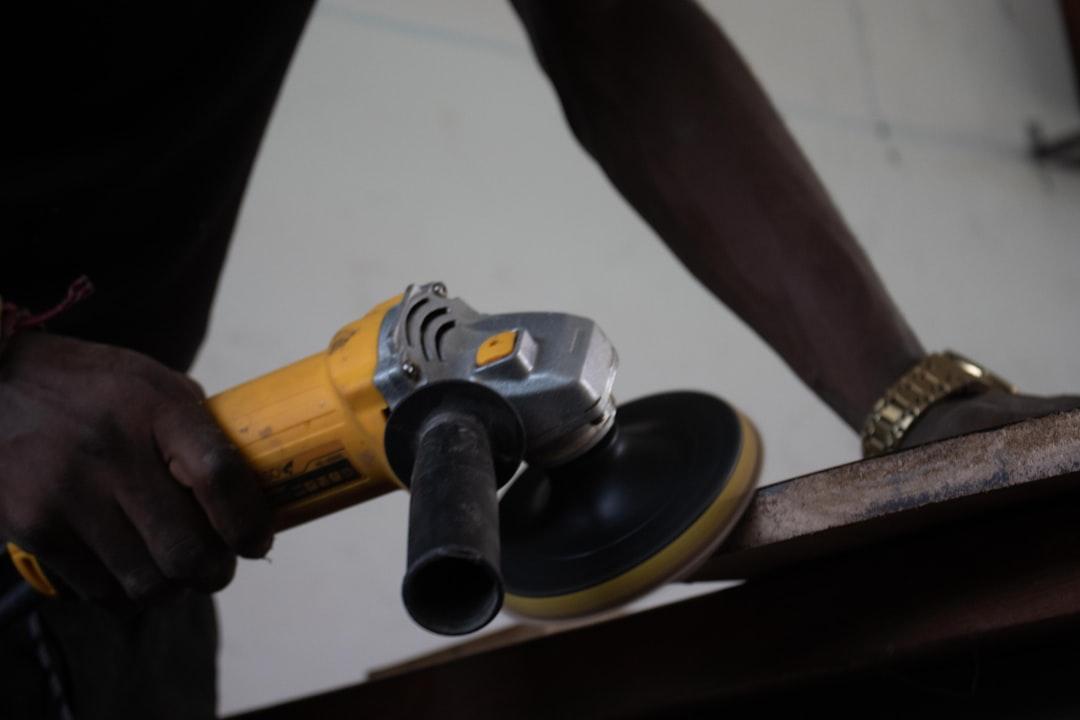 A person using a power tool on a piece of wood from Trésor Kande on Unsplash