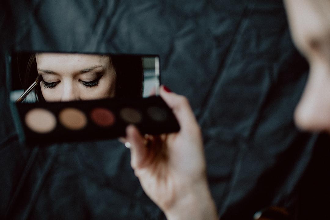 Woman holding black and silver make up palette from Kelly Sikkema on Unsplash