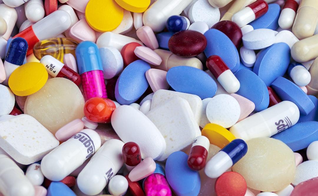 White blue and orange medication pill from Myriam Zilles on Unsplash