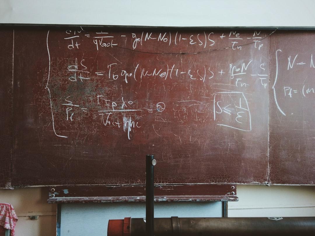 Written equations on brown wooden board from Roman Mager on Unsplash
