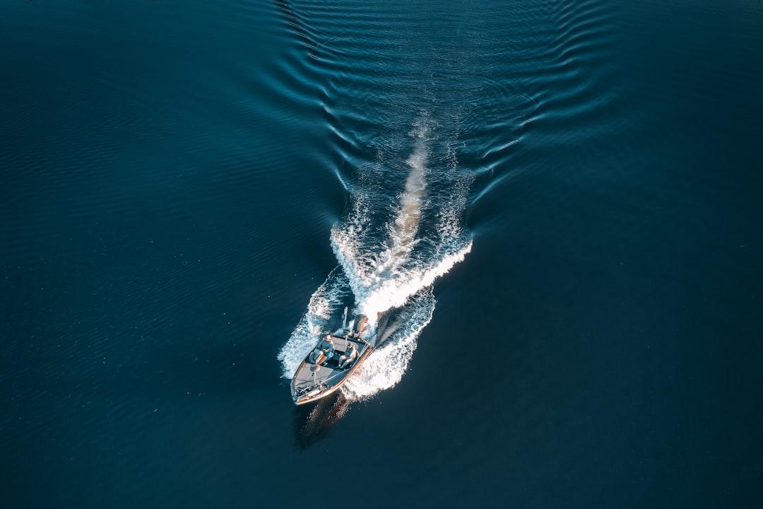 A small boat in the middle of a body of water from Drew Dau on Unsplash