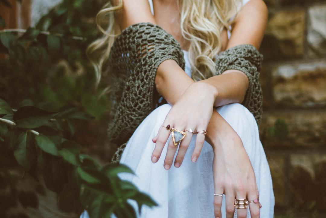 Woman sitting beside plant and concrete wall from Brooke Cagle on Unsplash