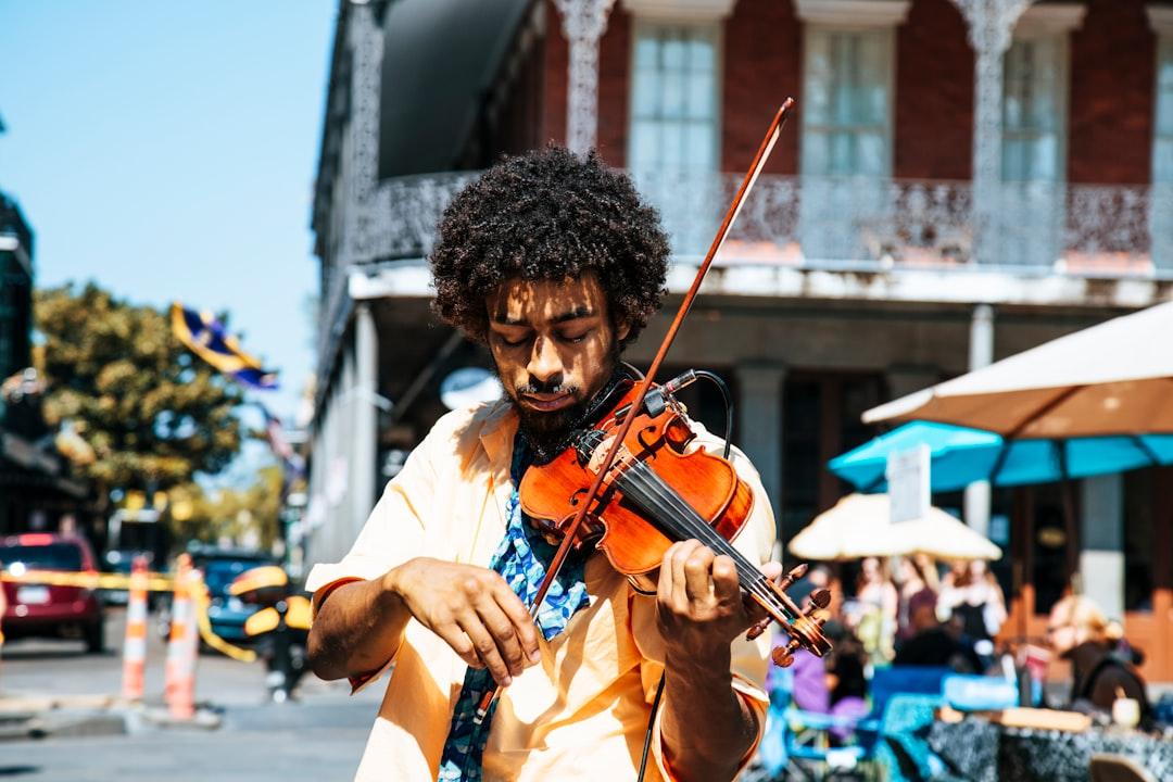 A man playing the violin or fiddle on the streets in new orleans in the french quarter from William Recinos on Unsplash