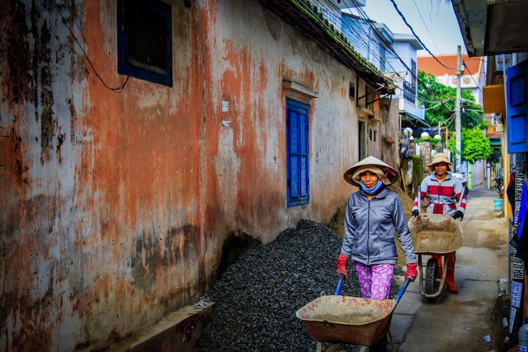 Two women walking beside orange house from Kate Ferguson on Unsplash
