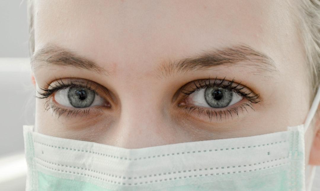Closeup photo of woman's eye wearing mask from Ani Kolleshi on Unsplash