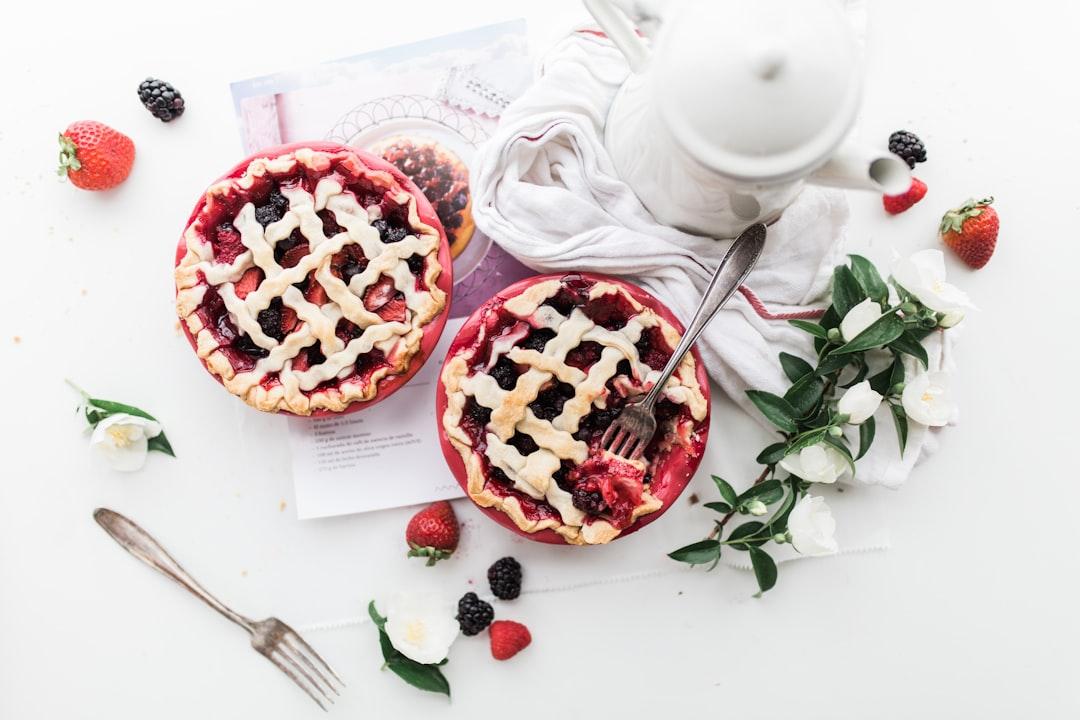 Baked pie near white ceramic teapot from Brooke Lark on Unsplash