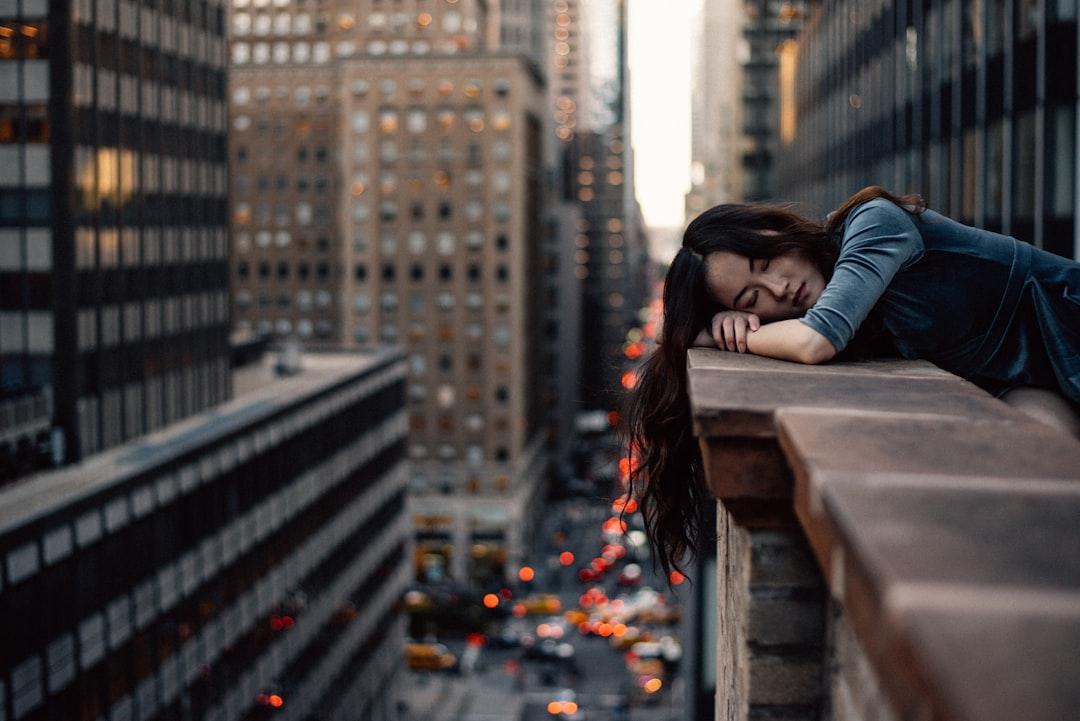 Woman leaning on top building rail during daytime from Hernan Sanchez on Unsplash