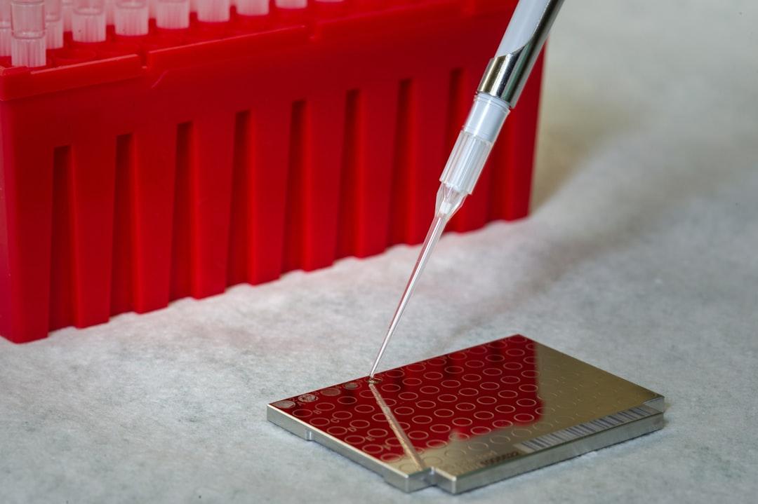 A needle is inserted into a piece of metal from CDC on Unsplash