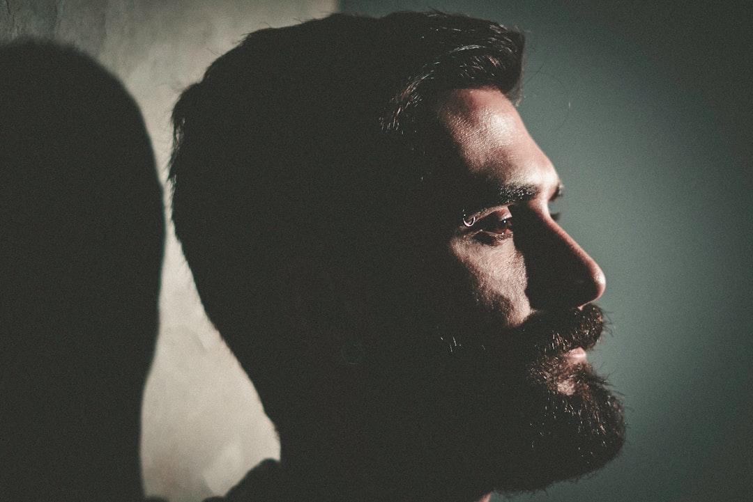 Closeup photo of man with beard from Vinicius "amnx" Amano on Unsplash