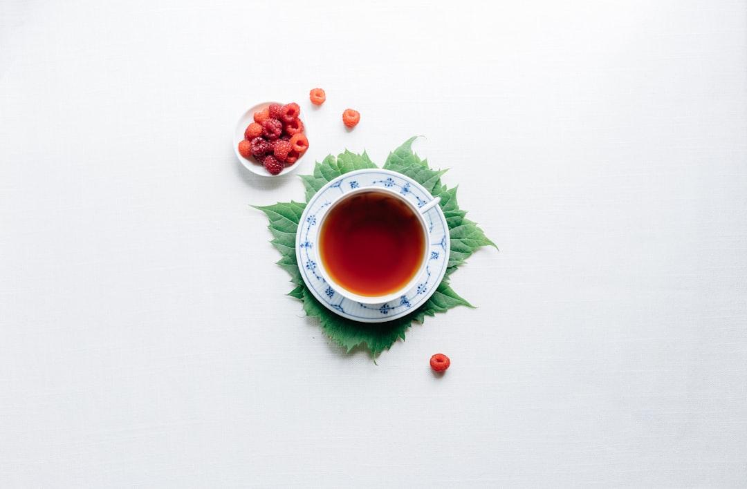 Round white cup with saucer filled with red liquid from Erol Ahmed on Unsplash