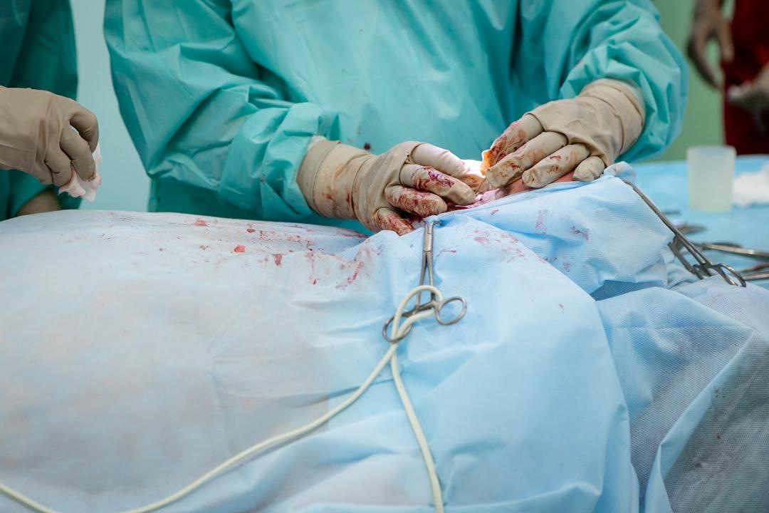 Person in operation gown holding scissors from Olga Kononenko on Unsplash
