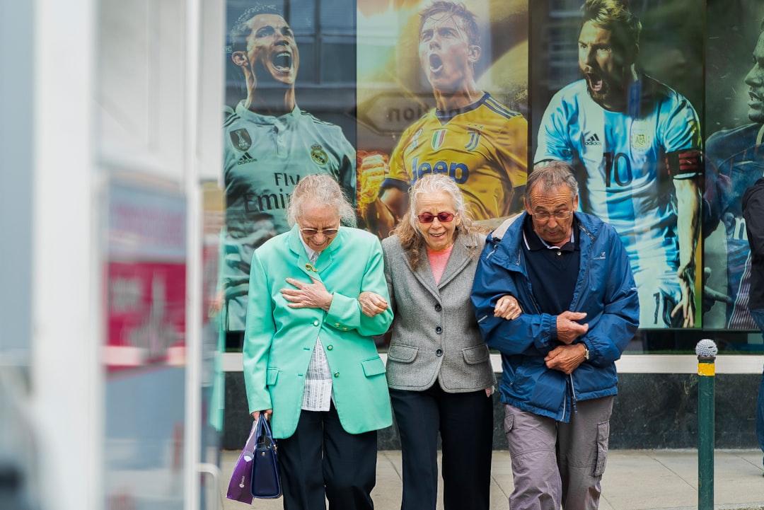 Two women and man walking in the street during daytime from Philippe Leone on Unsplash