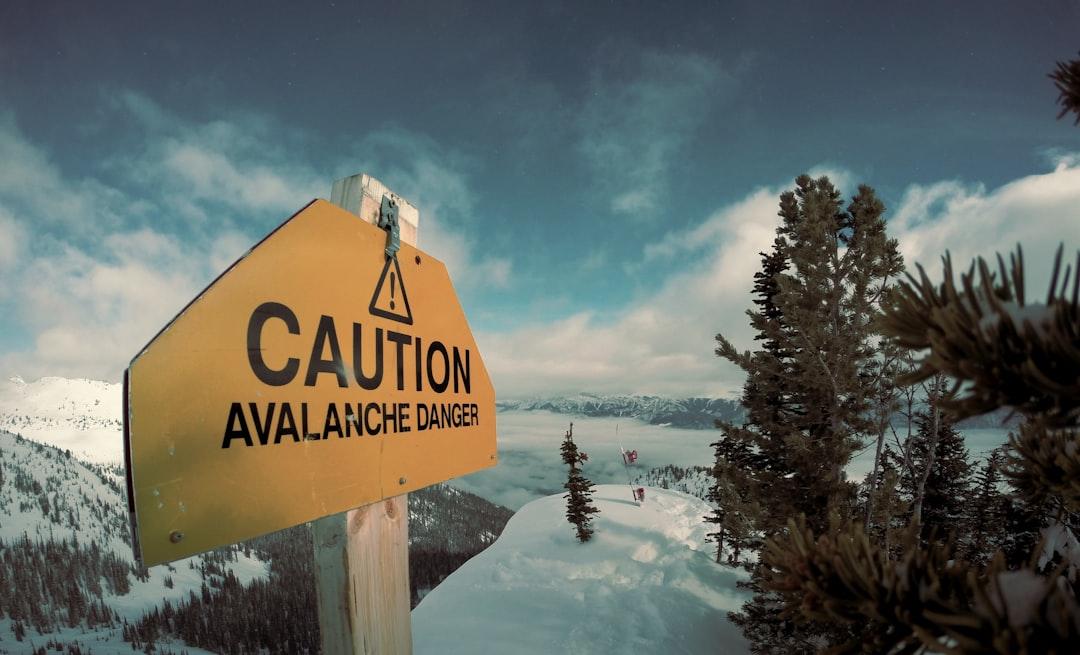 Caution avalanche danger signage during winter from Nicolas Cool on Unsplash