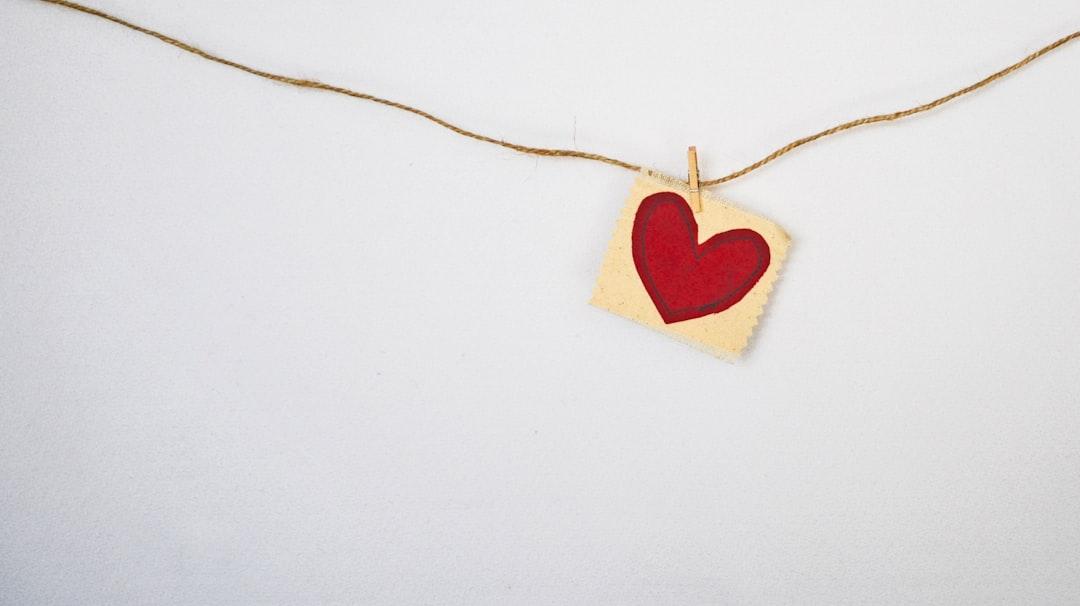 Heart-shaped red and beige pendant from Debby Hudson on Unsplash
