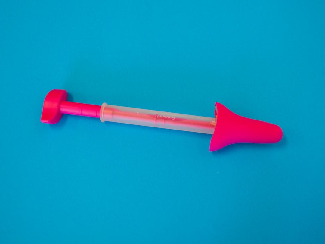 Red and white plastic stick from Testalize.me on Unsplash