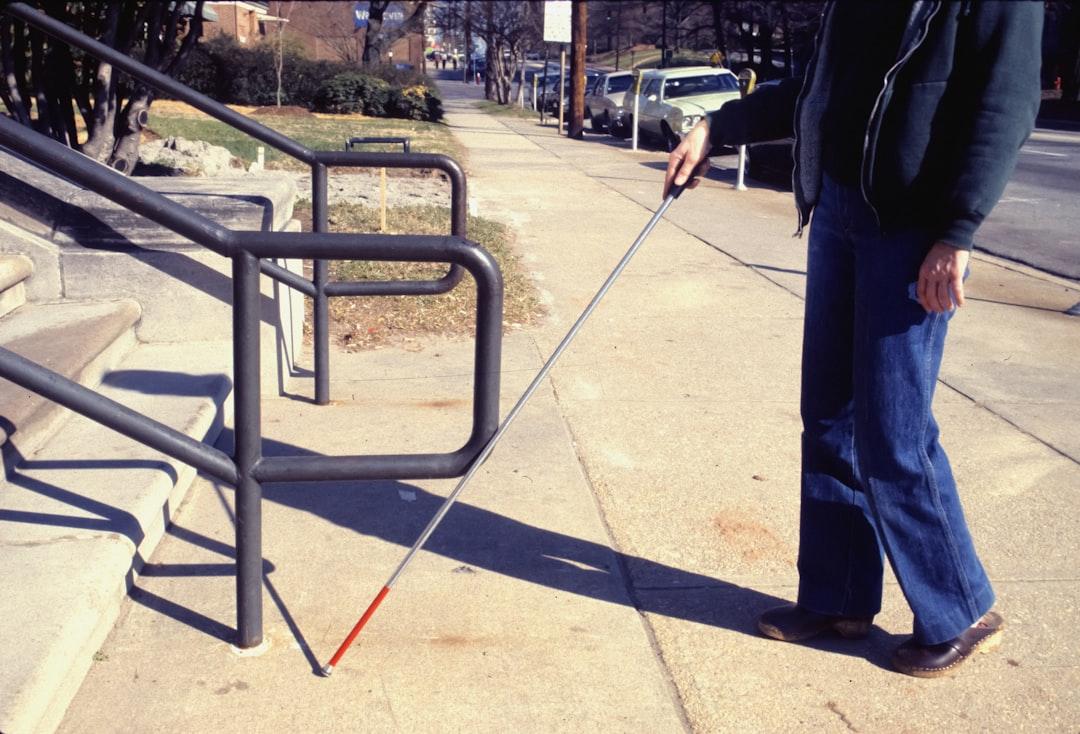 A man walking a dog on a leash down a sidewalk from CDC on Unsplash