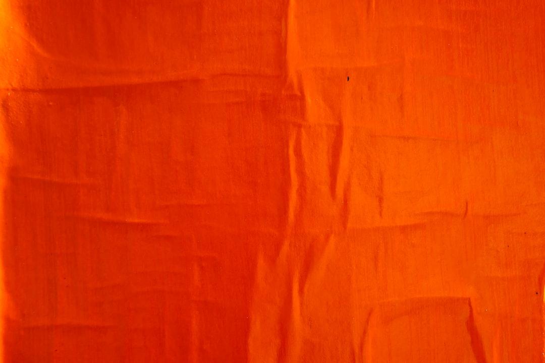 Orange textile on white textile from Bekky Bekks on Unsplash