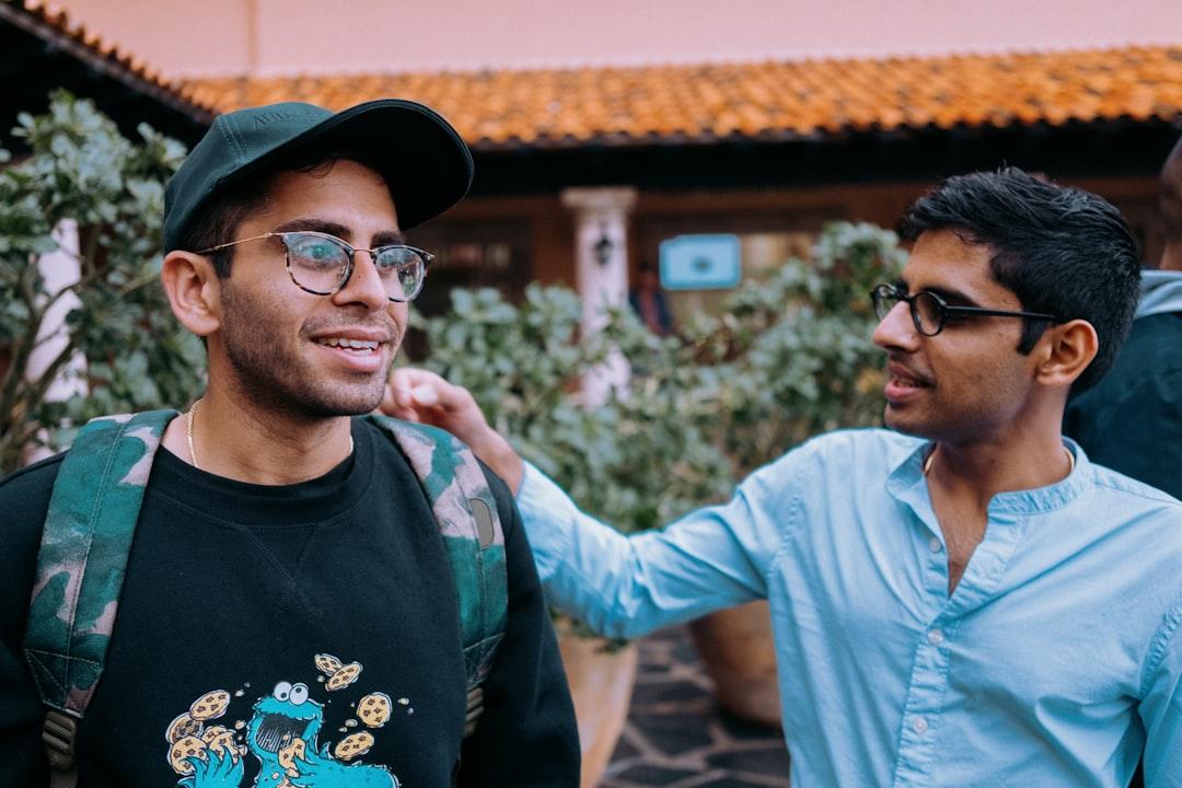 Man in black crew neck shirt wearing black framed eyeglasses and black hat from NONRESIDENT on Unsplash