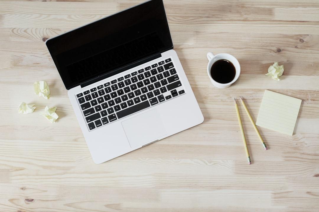 Turned off macbook pro beside white ceramic mug filled with coffee from Lauren Mancke on Unsplash
