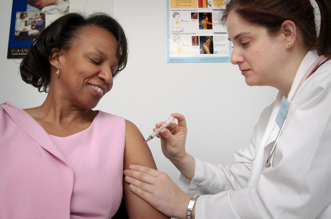 Woman getting vaccine from CDC on Unsplash