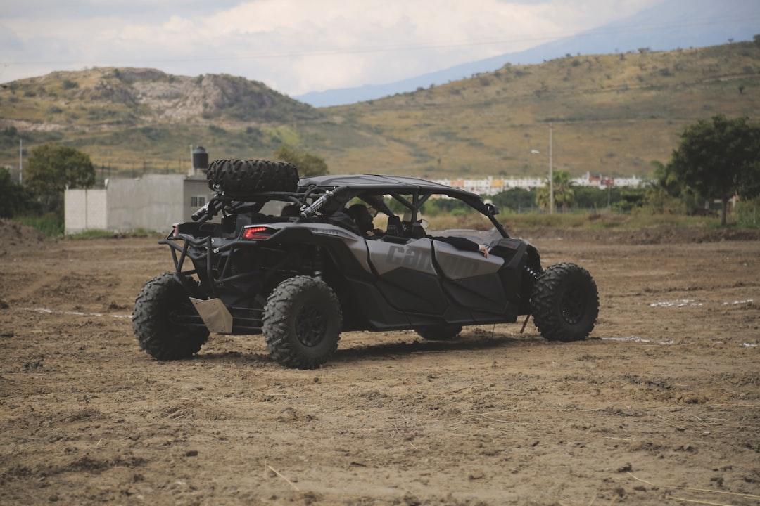 Black utv on field during daytime from Vico Luna on Unsplash