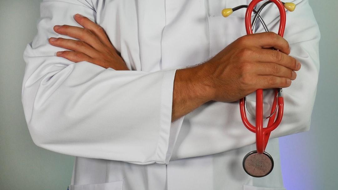 Doctor holding red stethoscope from Online Marketing on Unsplash