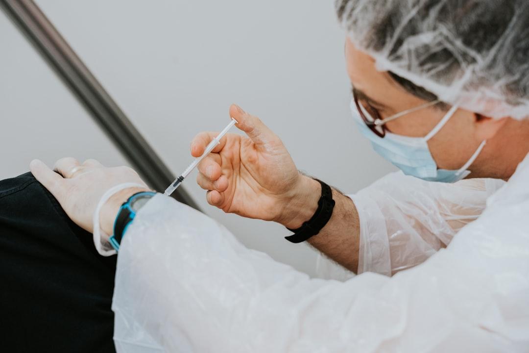 Person in white long sleeve shirt holding gray pen from Mathurin NAPOLY / matnapo on Unsplash