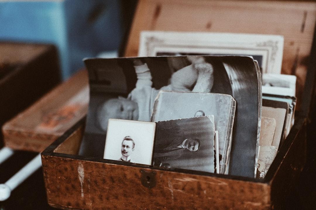 Old photos in brown wooden chest from Roman Kraft on Unsplash
