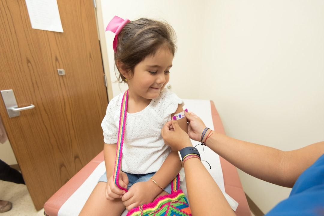 Girl getting vaccine from CDC on Unsplash
