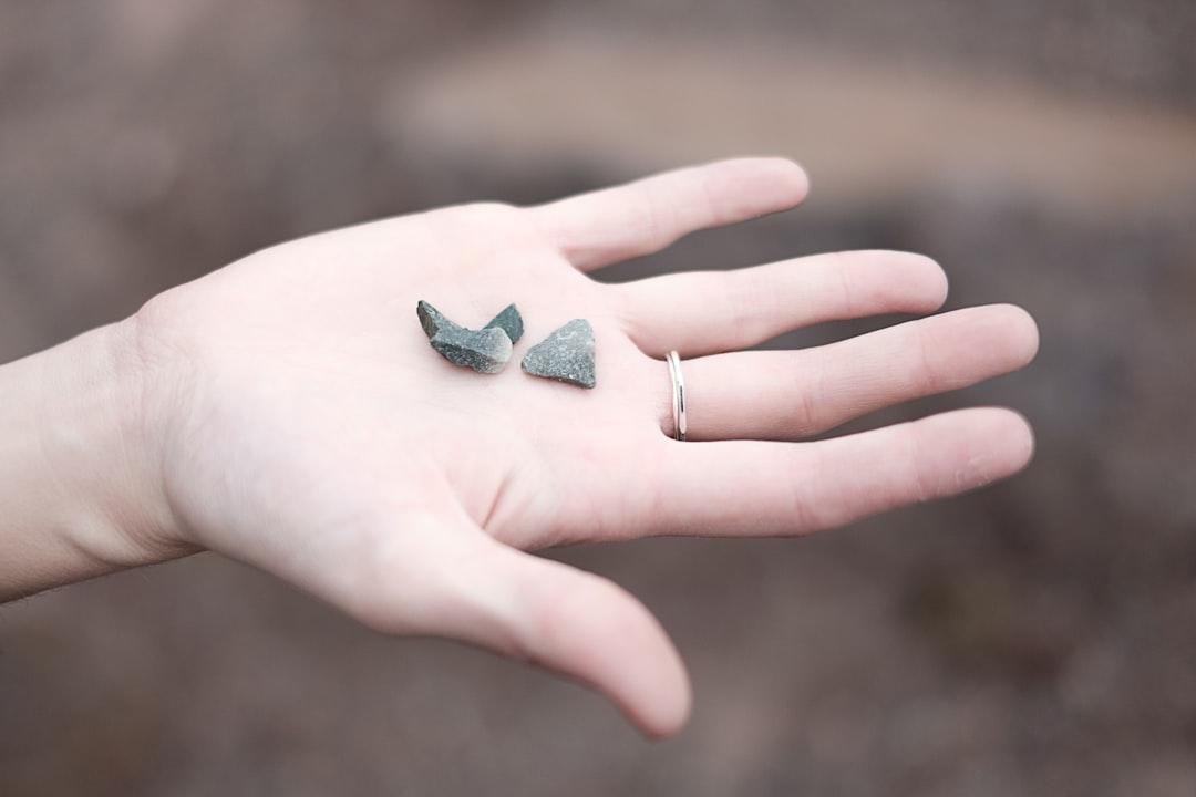 Three gray pebbles on person's palm from Felipe Elioenay on Unsplash
