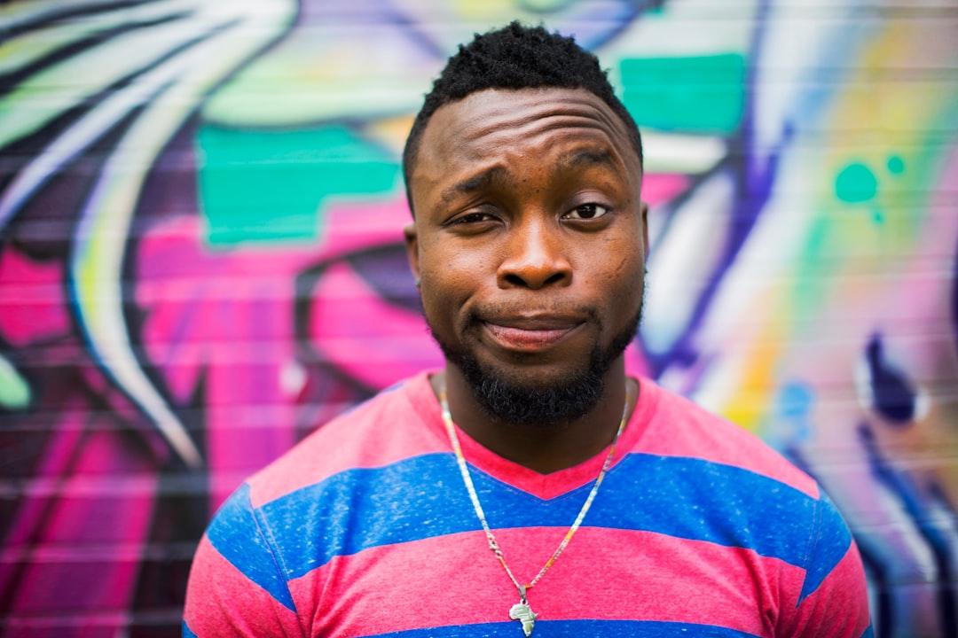 Black haired man making face from Ayo Ogunseinde on Unsplash