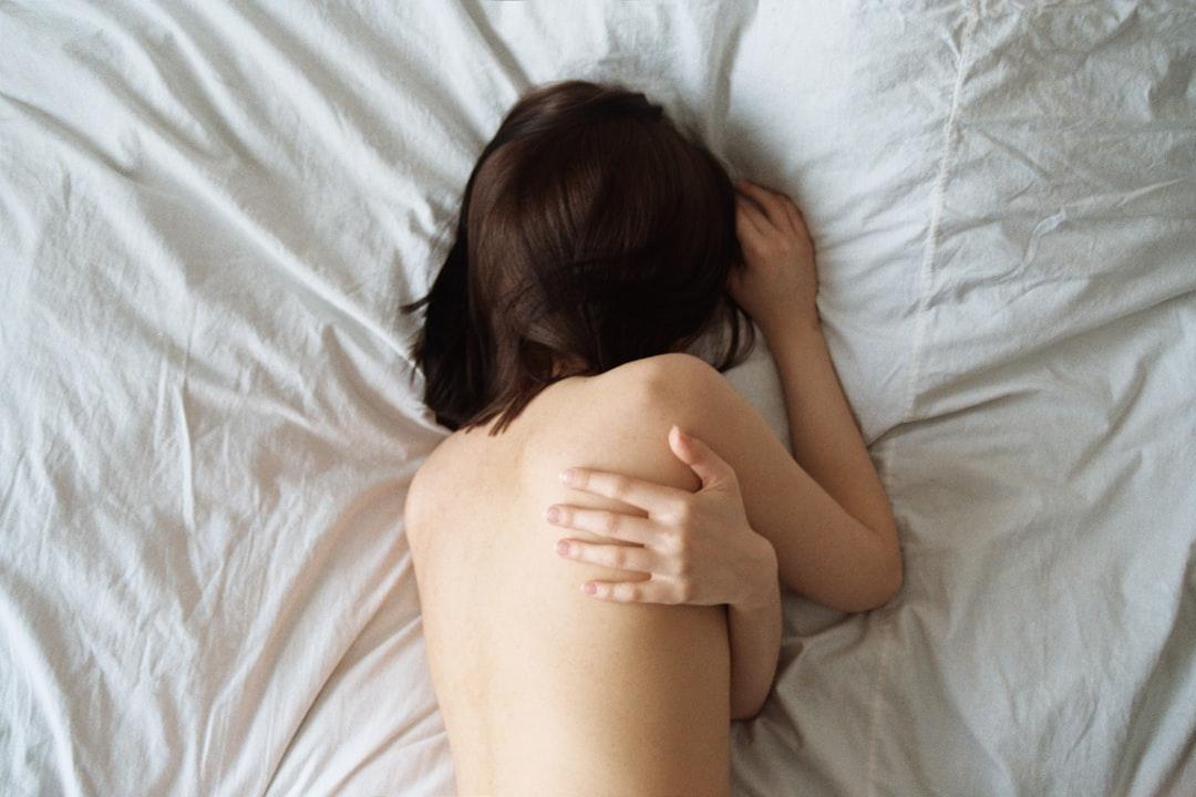 Woman lying on white bed from Oleg Ivanov on Unsplash