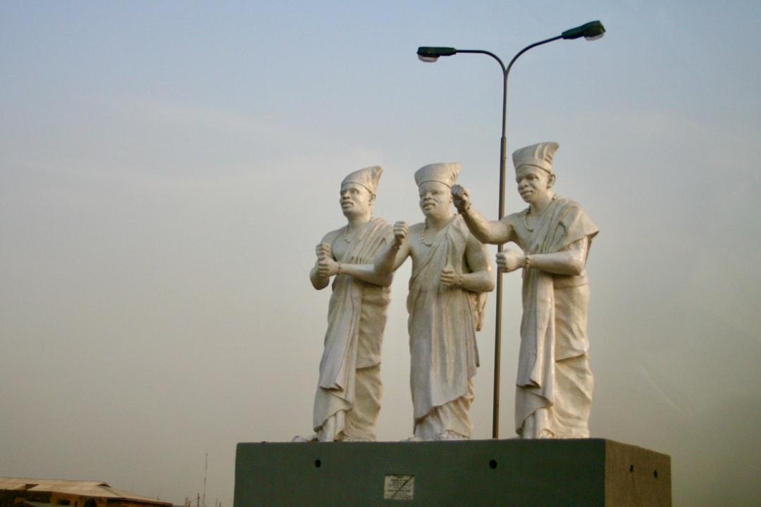 A group of statues of men standing next to each other from Amir Mortezaie on Unsplash