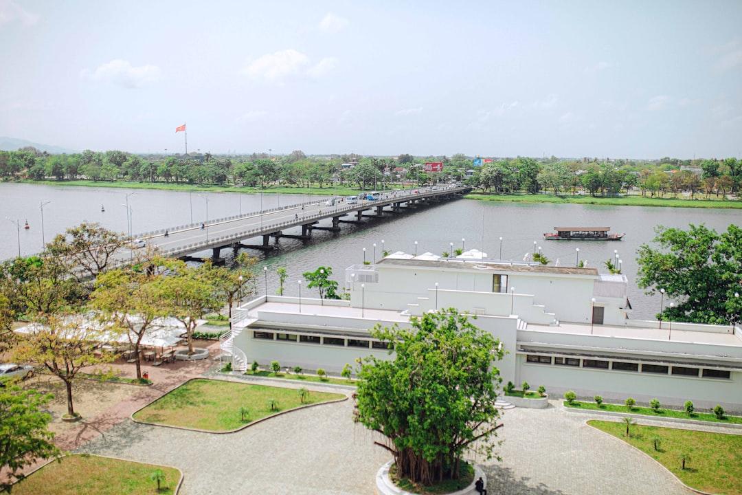 A large body of water with a bridge in the background from Khanh Nguyen on Unsplash