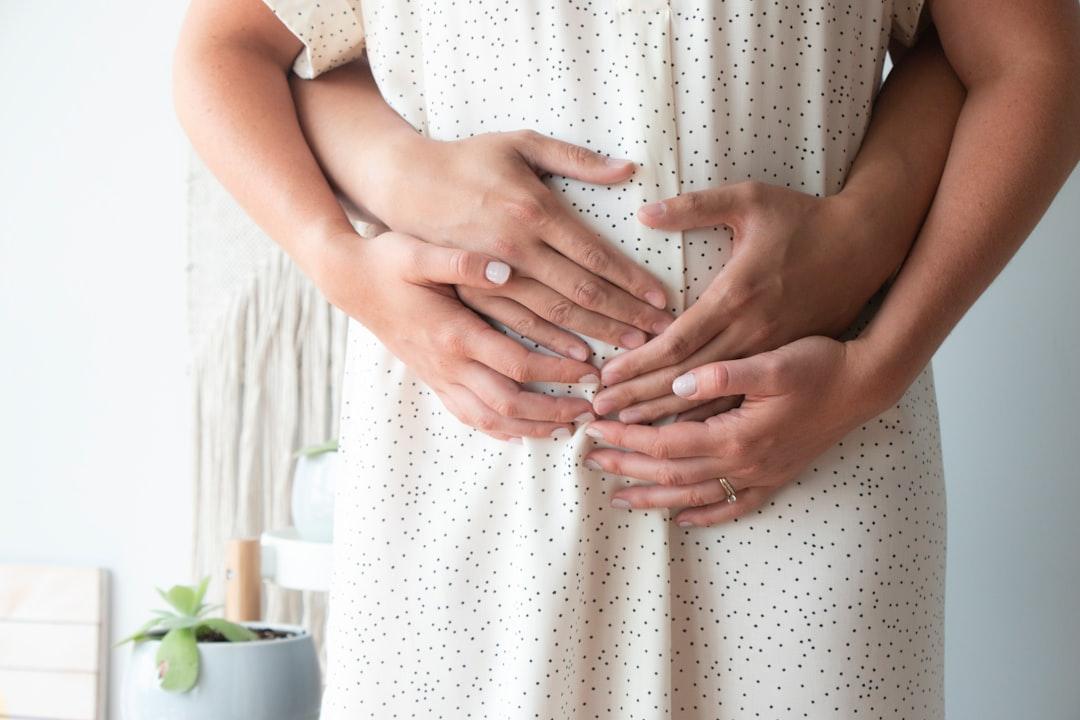Person touching person's belly from John Looy on Unsplash U xơ tử cung có thể khó có thai