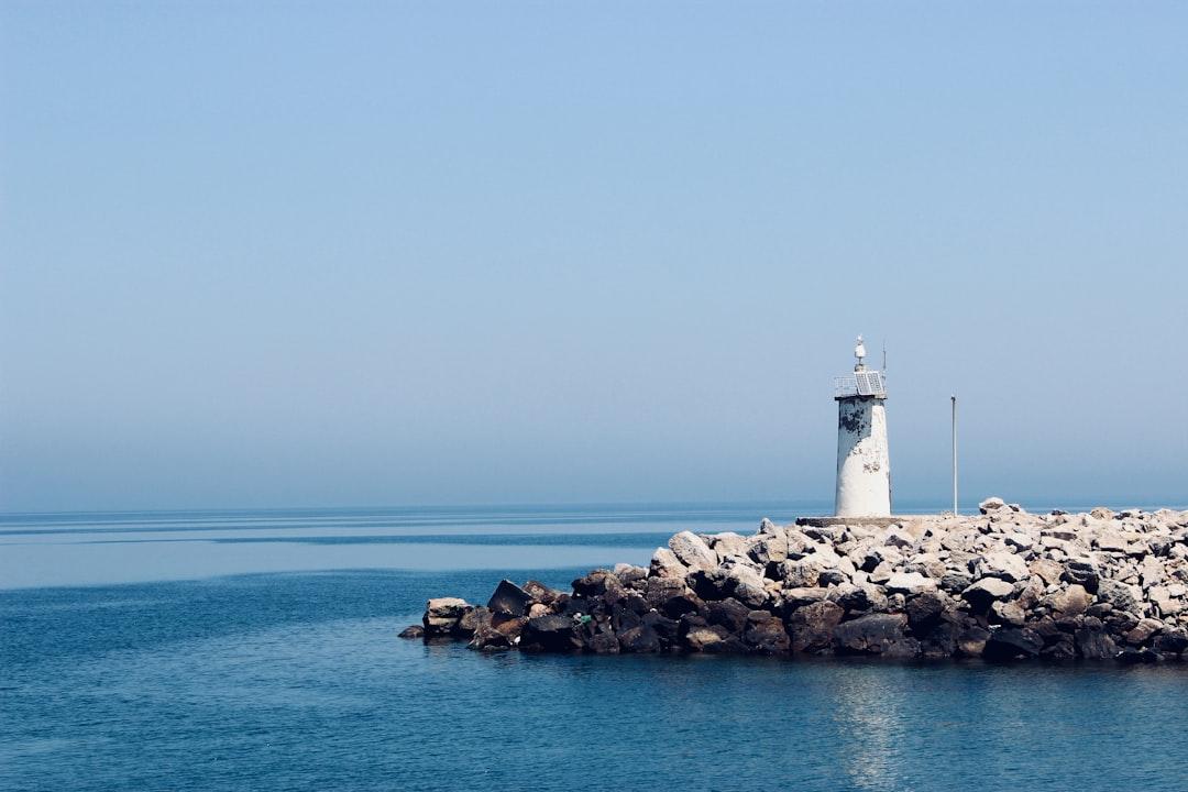 Photograph of white lighthouse on rocks from Özgür Akman on Unsplash Chữa chứng tiểu đêm nhiều lần