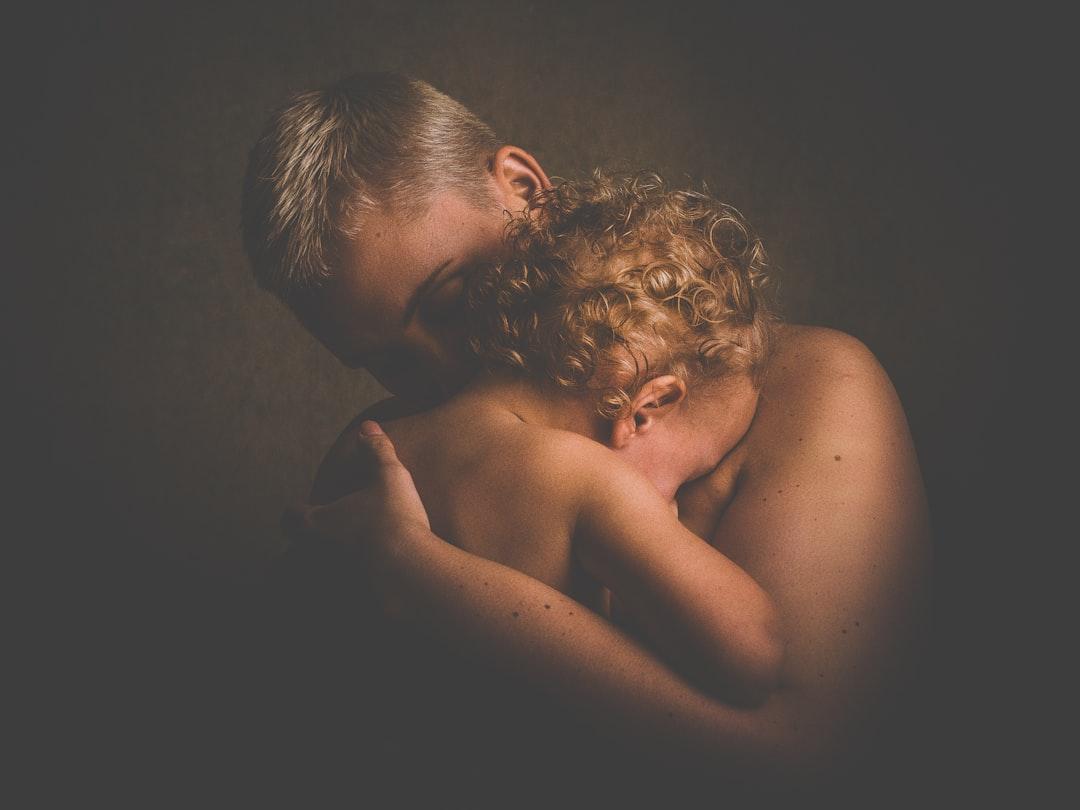 Topless person carrying children from 🇸🇮 Janko Ferlič on Unsplash