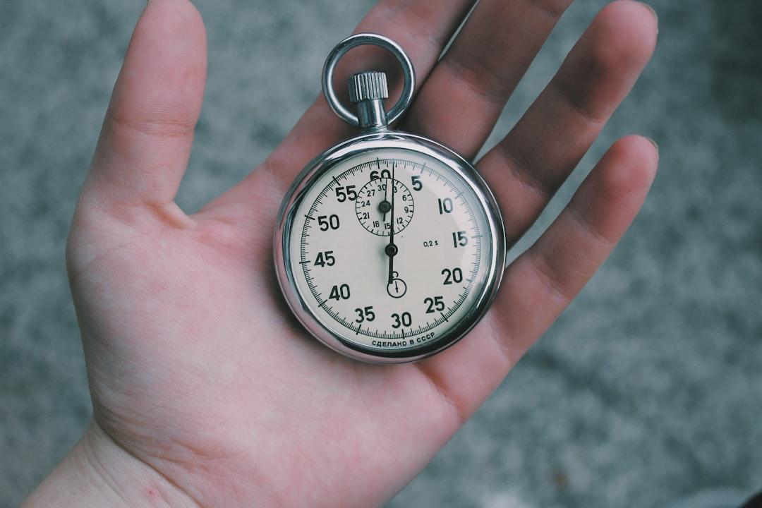 Person holding white and silver-colored pocket watch from Veri Ivanova on Unsplash
