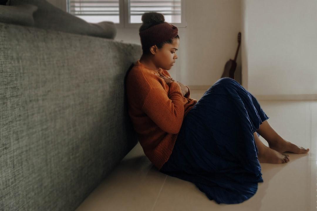 Man in orange long sleeve shirt sitting on gray couch from Joice Kelly on Unsplash