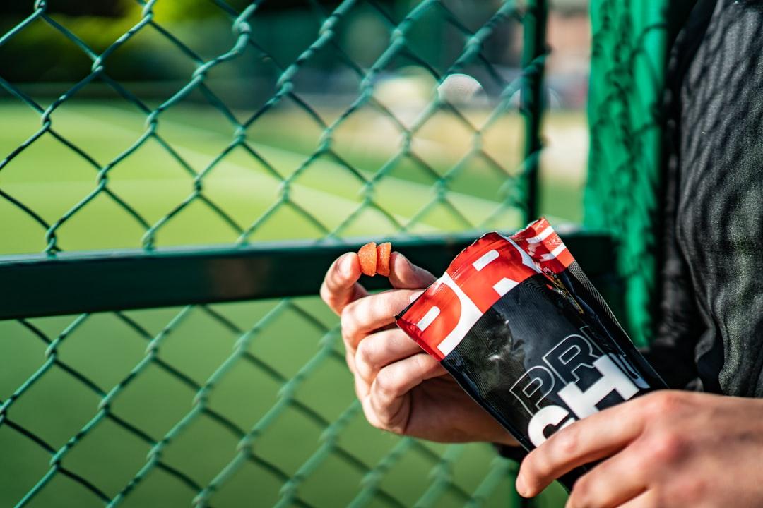 A person holding a bottle from CHU Gummies on Unsplash