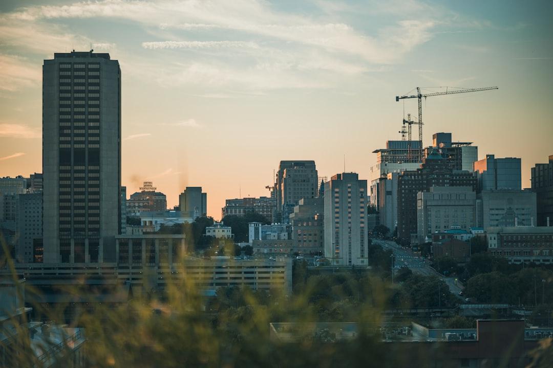 A view of a city skyline with a crane in the background from Nathaniel Villaire on Unsplash
