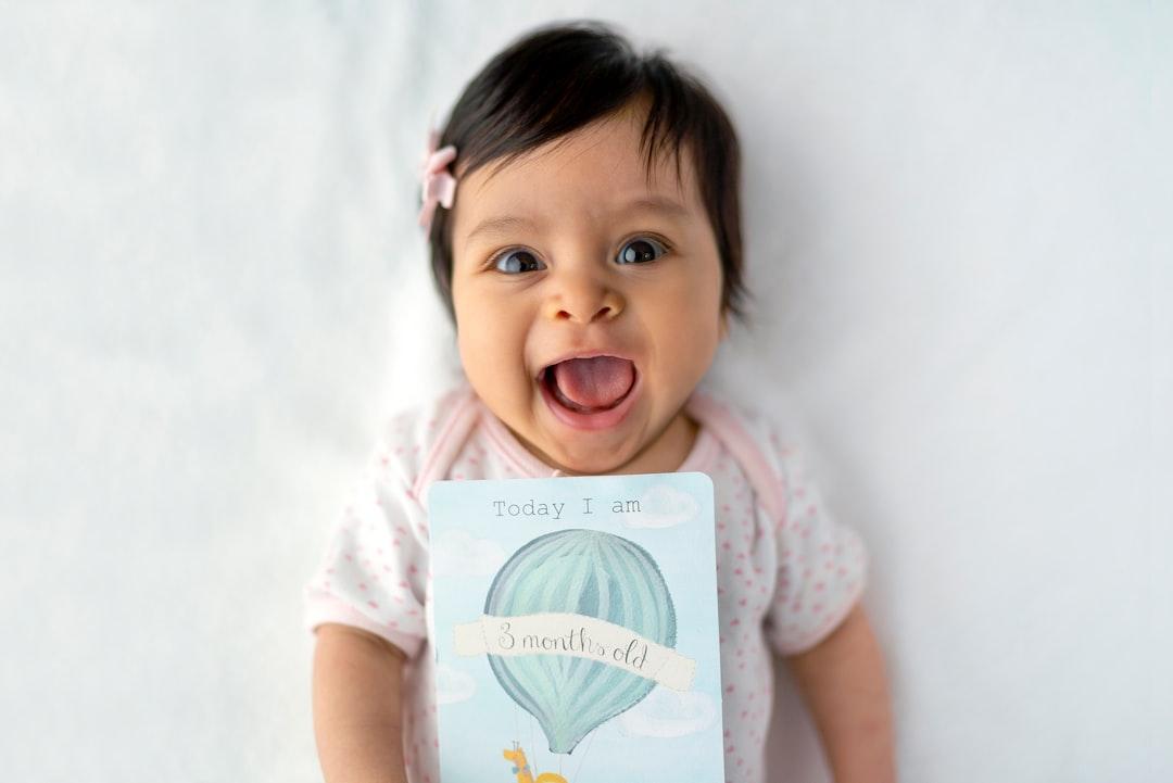 Baby with 8 months old card from Juan Encalada on Unsplash